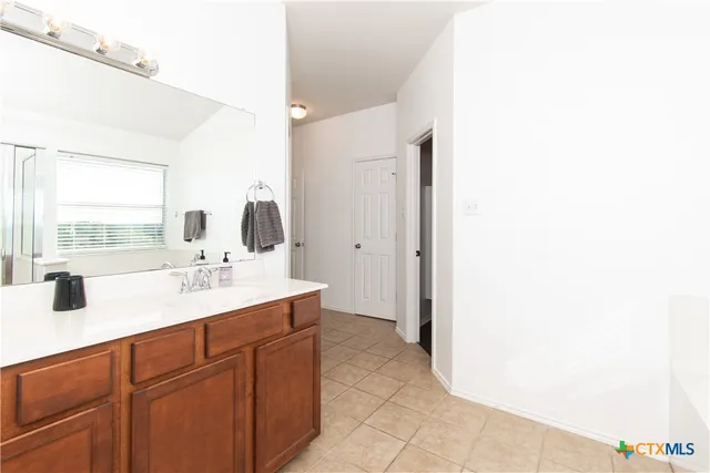a bathroom with a double vanity sink and mirror