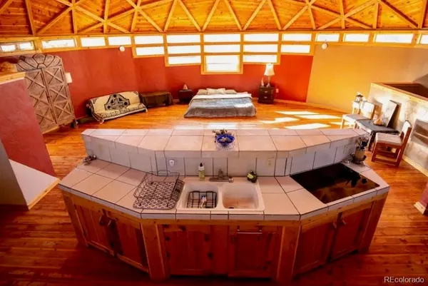 a bed sitting in a bedroom next to a window