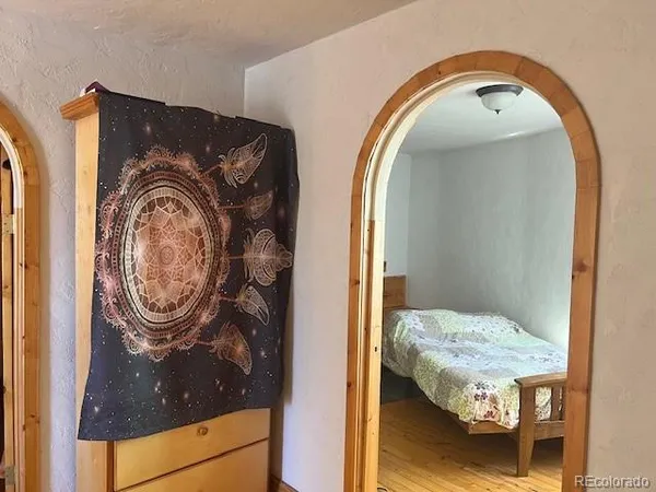 a bedroom with a bed and a mirror