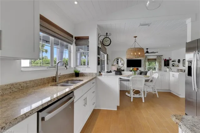 a large white kitchen with a table and chairs