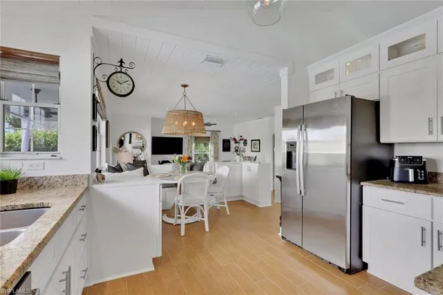 a kitchen with stainless steel appliances granite countertop a sink a stove and refrigerator