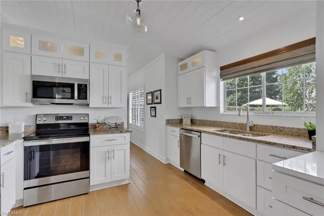a kitchen with a sink stove and microwave