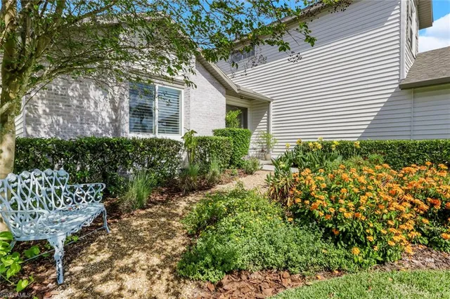 a view of a house with a yard and sitting area