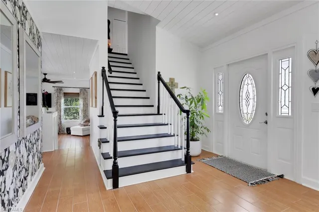 a view of entryway with stairs and wooden floor