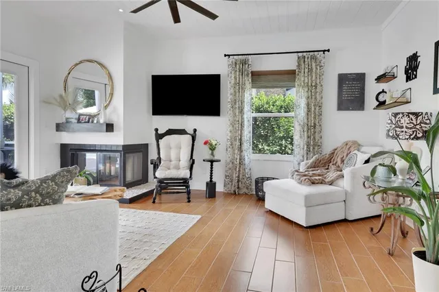 a living room with furniture fireplace and a flat screen tv