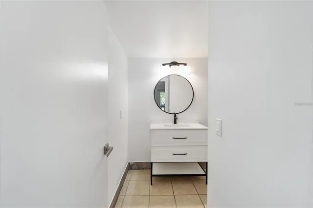 a room with wooden floor and mirror