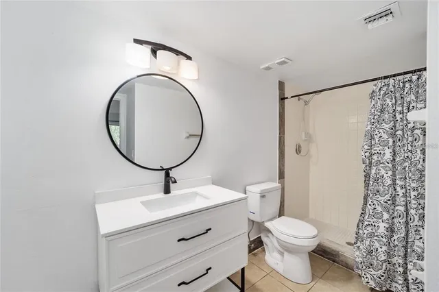 a bathroom with a toilet a sink and a mirror