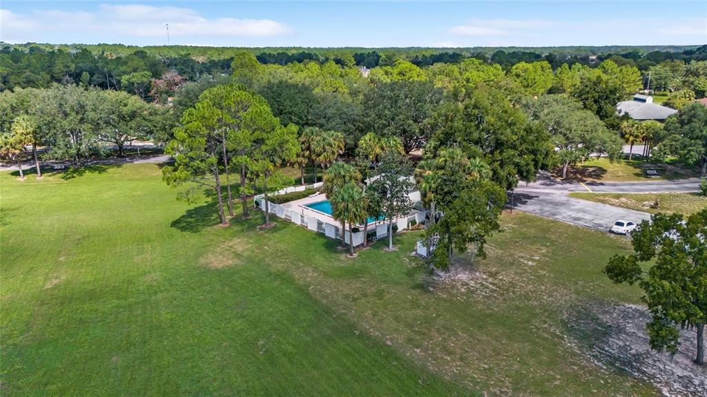 8202 Fairways Circle, Unit B202 Ocala, FL 34472 - Photo 23 of 27 a view of a garden with a building in the background