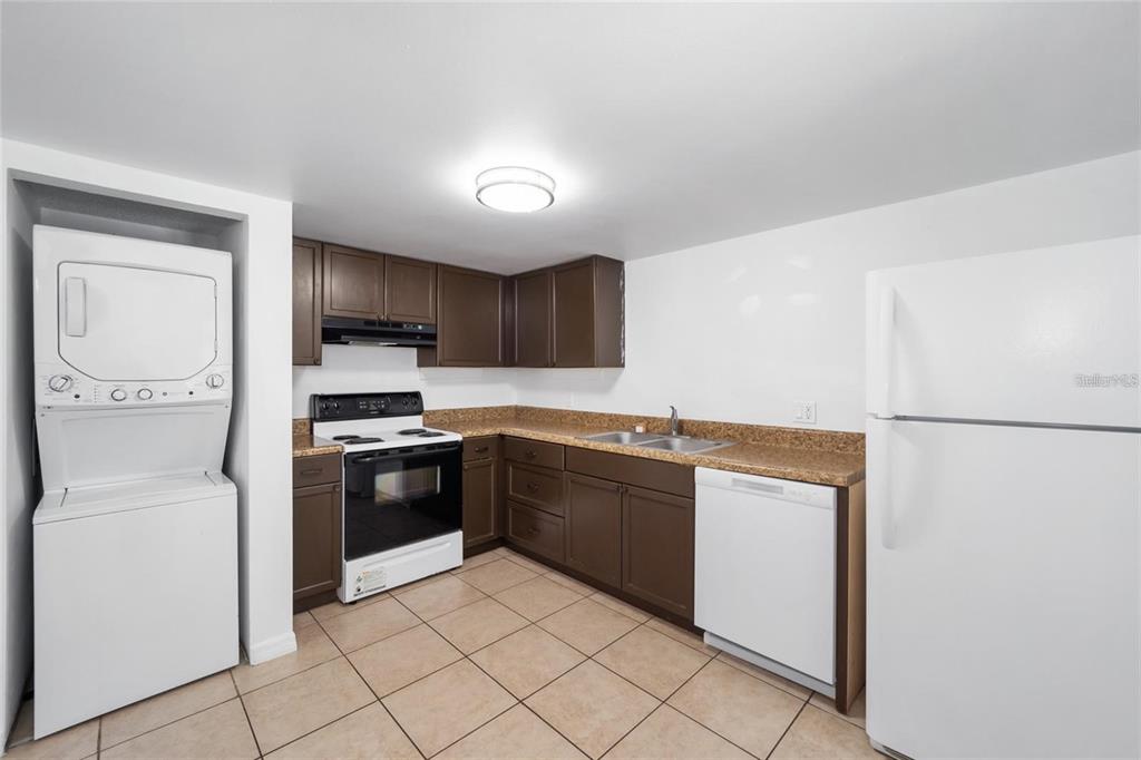 8202 Fairways Circle, Unit B202 Ocala, FL 34472 - Photo 10 of 27 a kitchen with stainless steel appliances granite countertop a refrigerator sink and stove