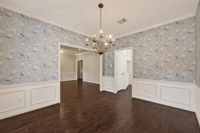 a view of a livingroom with wooden floor and a ceiling fan