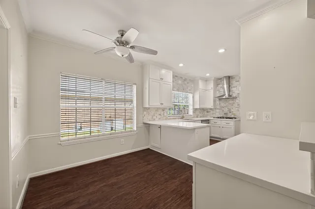 a kitchen with a stove a sink and cabinets