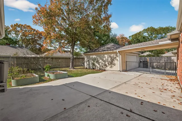 a view of a yard with yellow house
