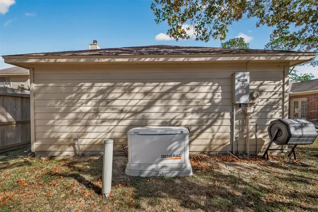 a view of water heater room with wooden floor