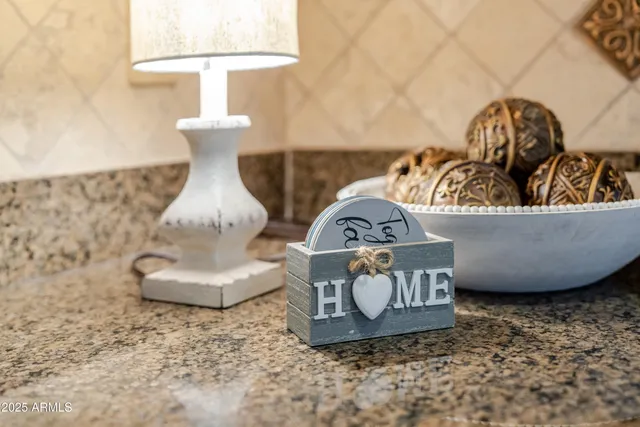 a kitchen with stainless steel appliances granite countertop a refrigerator a table and chairs