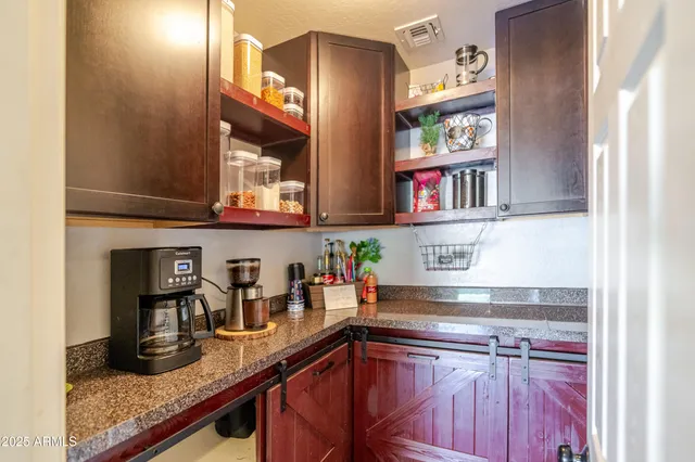 a kitchen with granite countertop a stove top oven microwave and cabinets