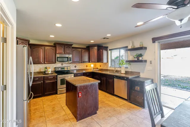 a kitchen with a sink and a stove top oven