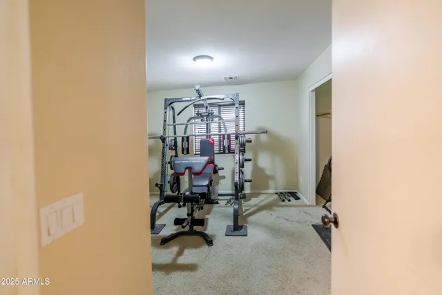 a view of a hallway with wooden floor and doors