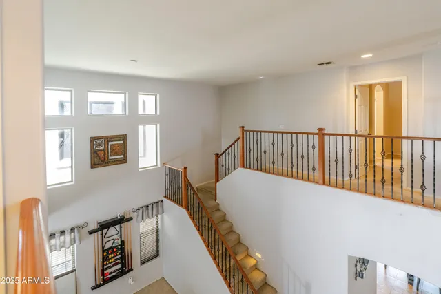 a bathroom with a granite countertop sink a potted plant and a window