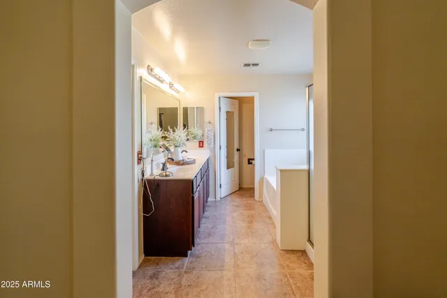 a bedroom with a bed a chandelier and a window