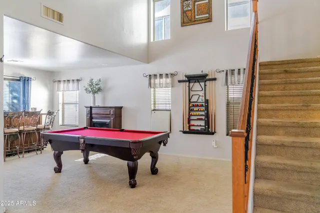 a room with pool table and a window
