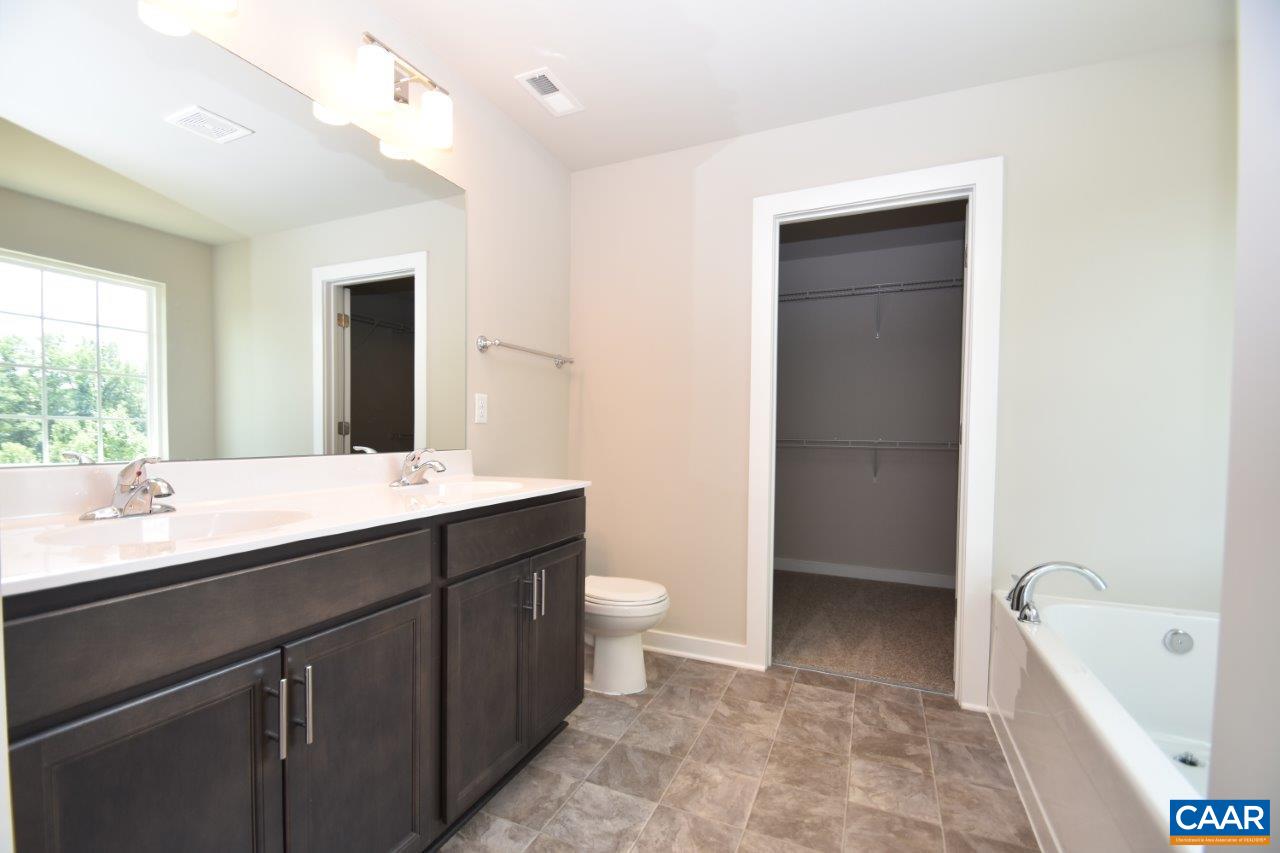 4696 Venable Road Kents Store, VA 23084 - Photo 20 of 28 a bathroom with a double vanity sink toilet and shower