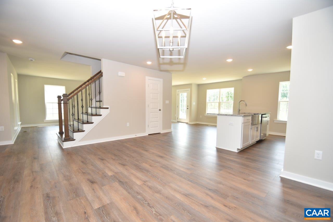 4696 Venable Road Kents Store, VA 23084 - Photo 10 of 28 a view of a hallway with wooden floor windows and a kitchen