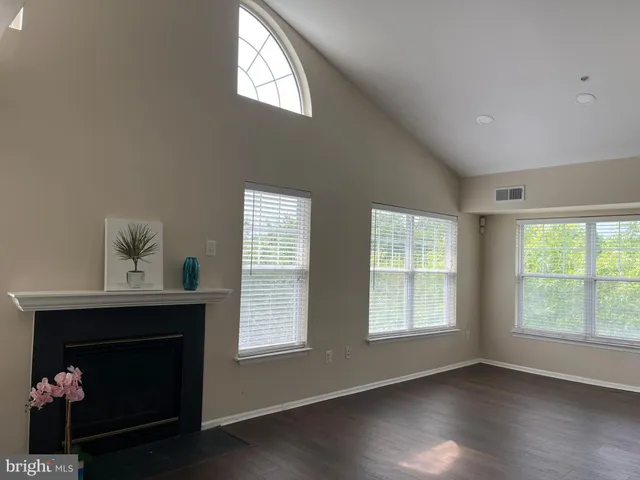 a living room with a fireplace and windows