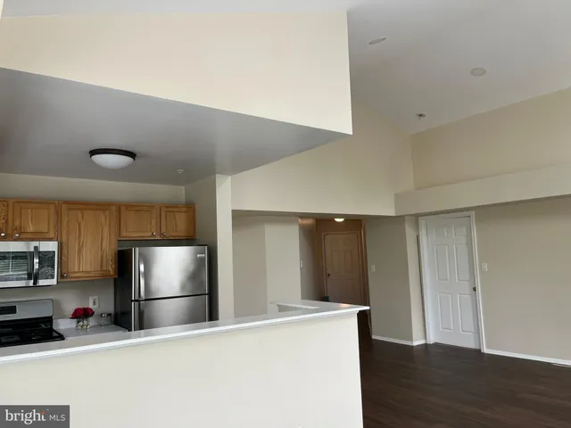 a kitchen with stainless steel appliances a refrigerator and a stove