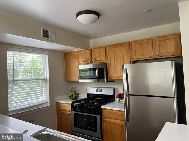 a white refrigerator freezer and a stove top oven