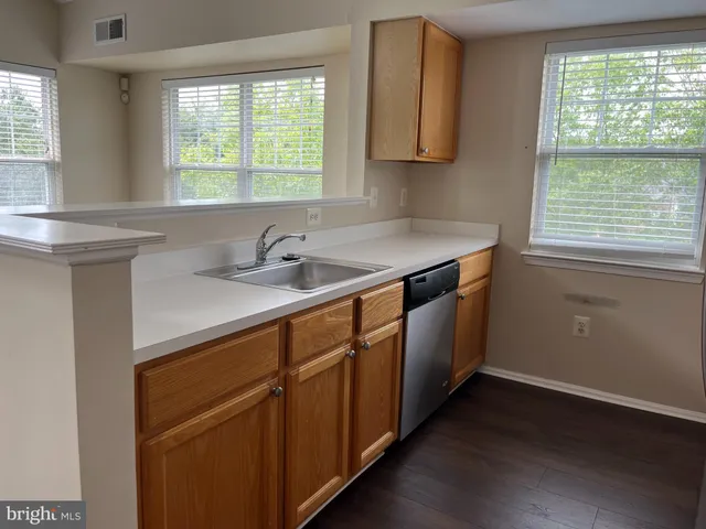 a kitchen with a sink and a window