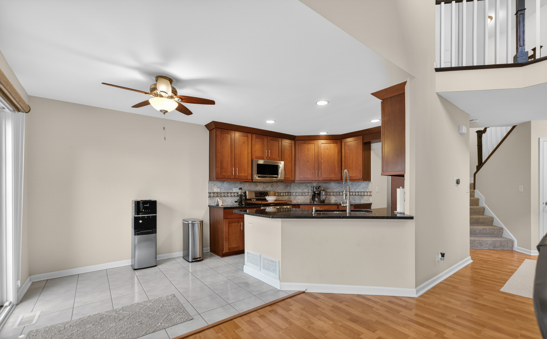 125 Ione Drive, Unit A South Elgin, IL 60177 - Photo 14 of 44 a view of a kitchen with stainless steel appliances granite countertop a refrigerator and a stove top oven
