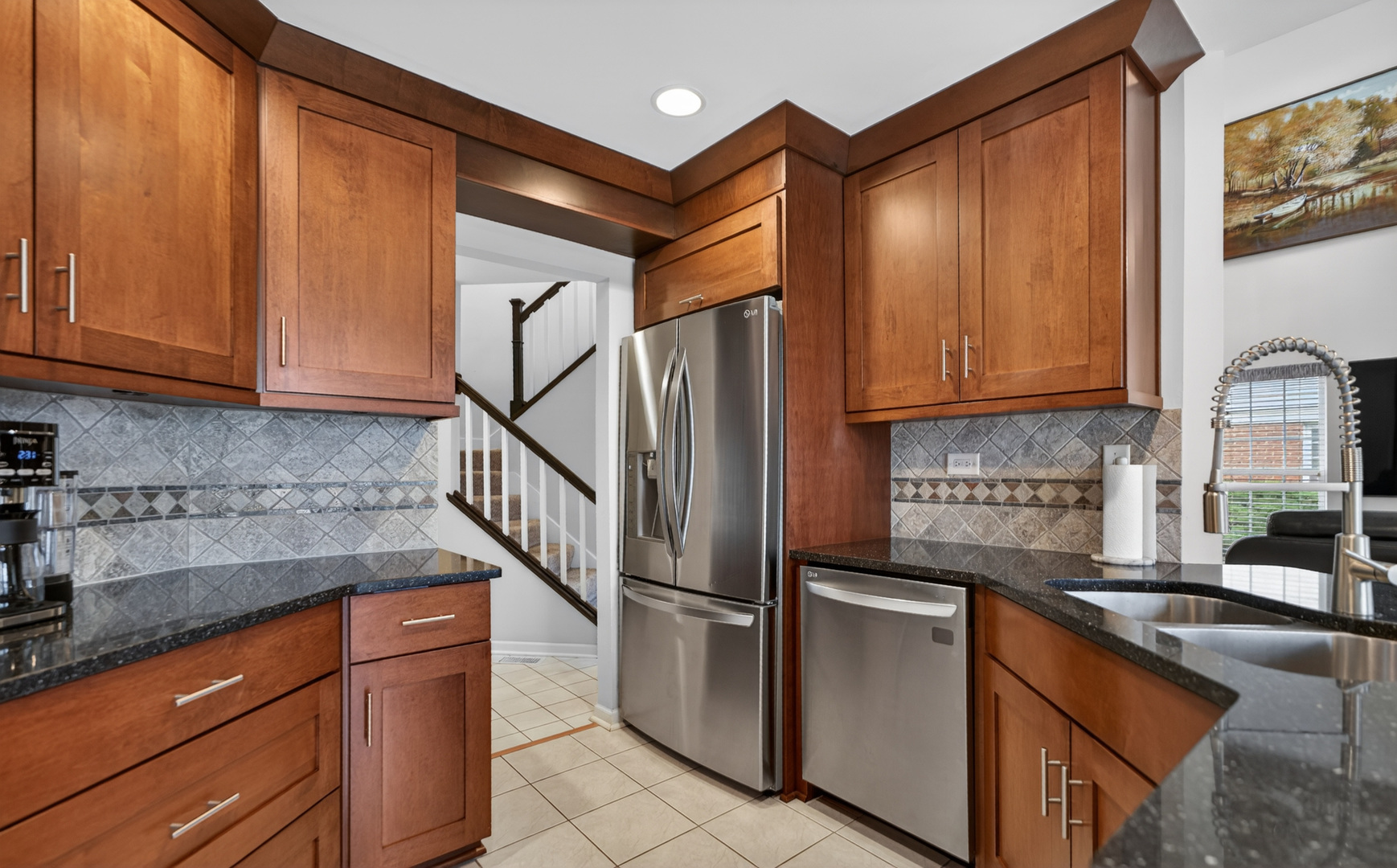 125 Ione Drive, Unit A South Elgin, IL 60177 - Photo 16 of 44 a kitchen with stainless steel appliances granite countertop a refrigerator and a sink