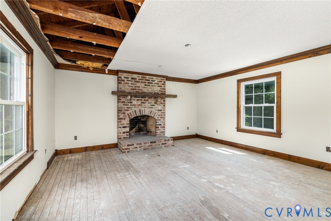 26081 Mason Road Jarratt, VA 23867 - Photo 15 of 49 Spacious living area showcasing exposed wood beam