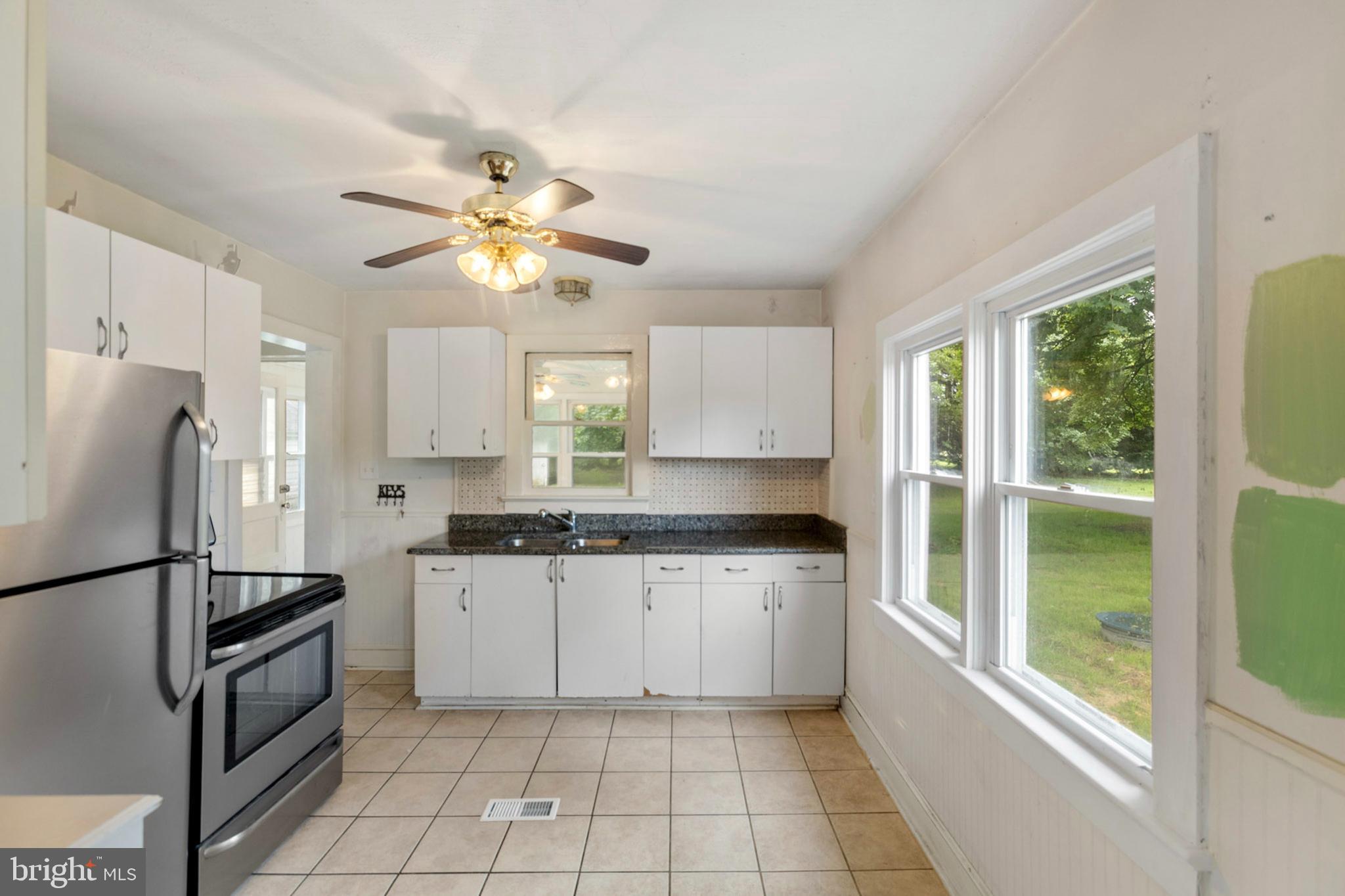934 Fieldsboro Road Townsend, DE 19734 - Photo 14 of 27 a kitchen with granite countertop a refrigerator a sink a stove a washer dryer and a cabinets