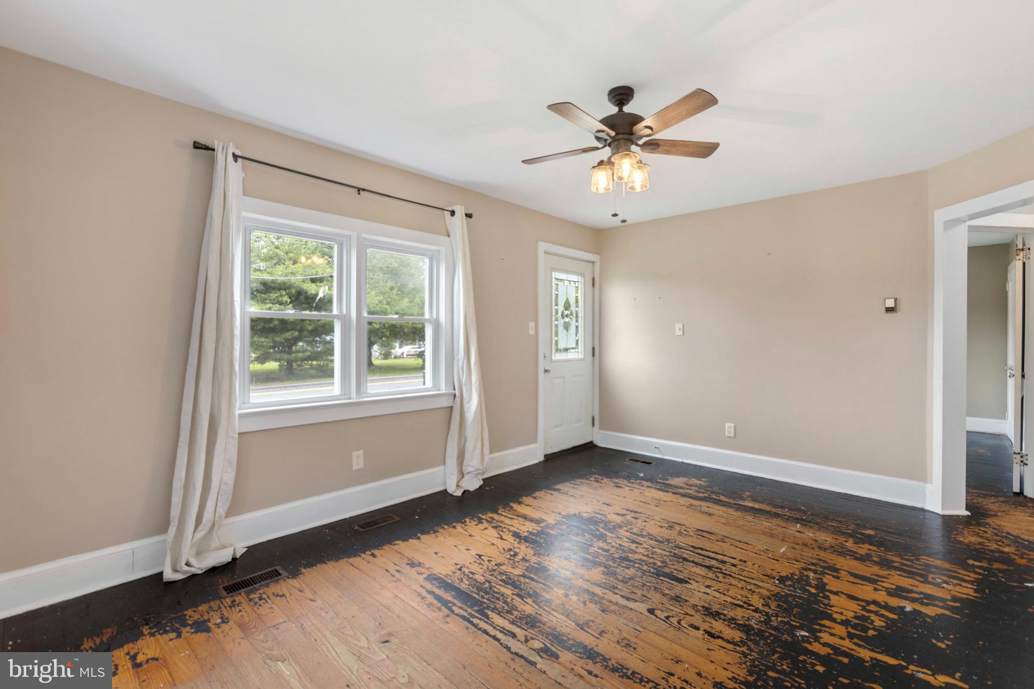 934 Fieldsboro Road Townsend, DE 19734 - Photo 8 of 27 a view of an empty room with wooden floor and a window
