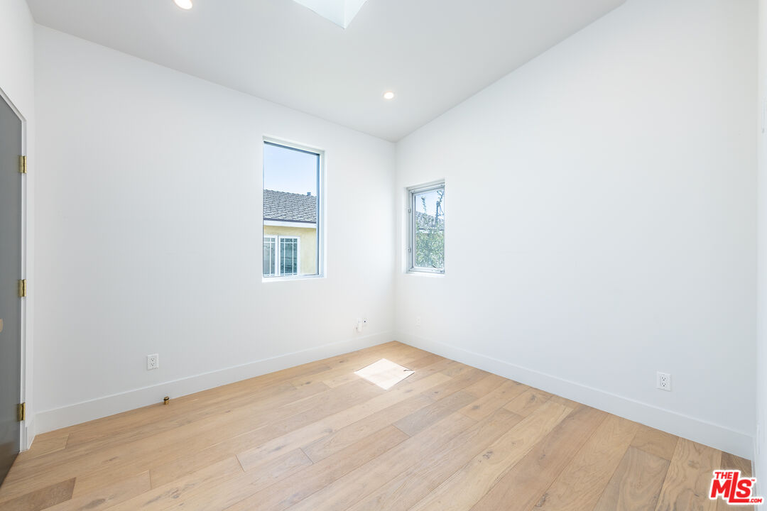 758 Sunset Avenue, Unit A Venice, CA 90291 - Photo 1 of 1 an empty room with wooden floor and windows