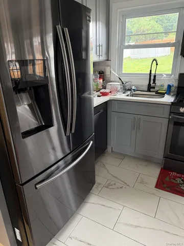 a kitchen with stainless steel appliances a sink stove and refrigerator