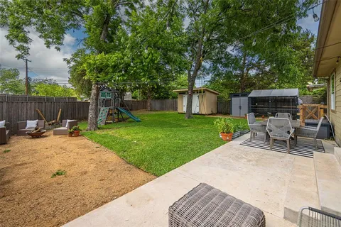 a view of backyard with swimming pool and patio