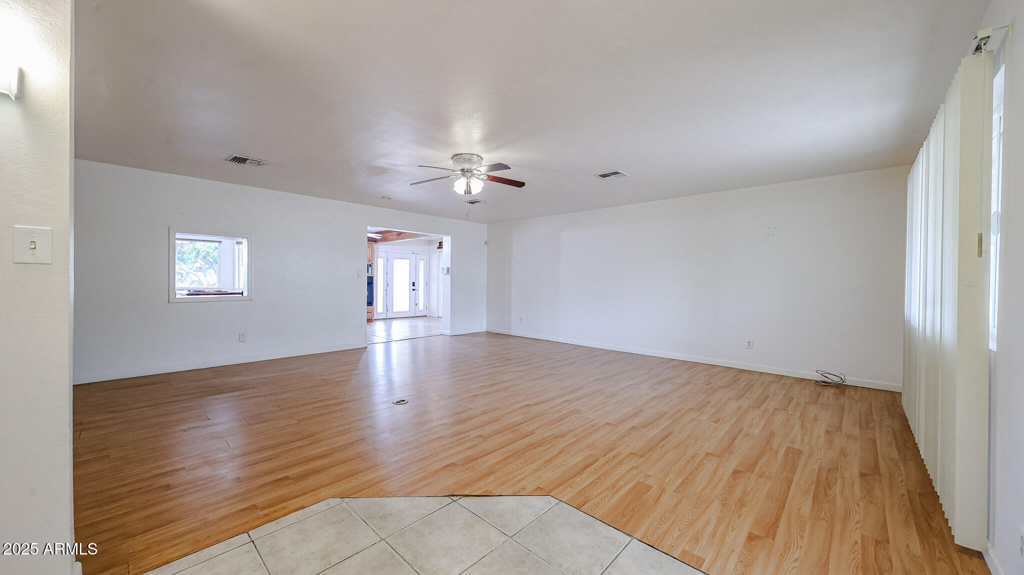 11851 North Thunderbird Road Sun City, AZ 85351 - Photo 6 of 46 wooden floor in an empty room with a window