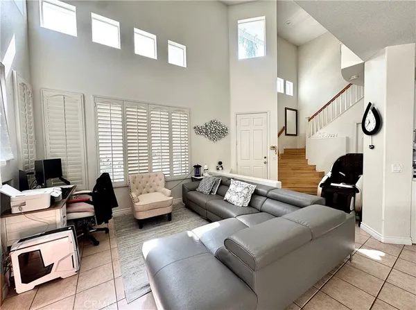 a bedroom with bed couch and window