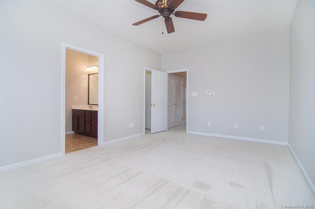 7510 Turley Ridge Lane Charlotte, NC 28273 - Photo 12 of 23 an empty room with chandelier fan and windows