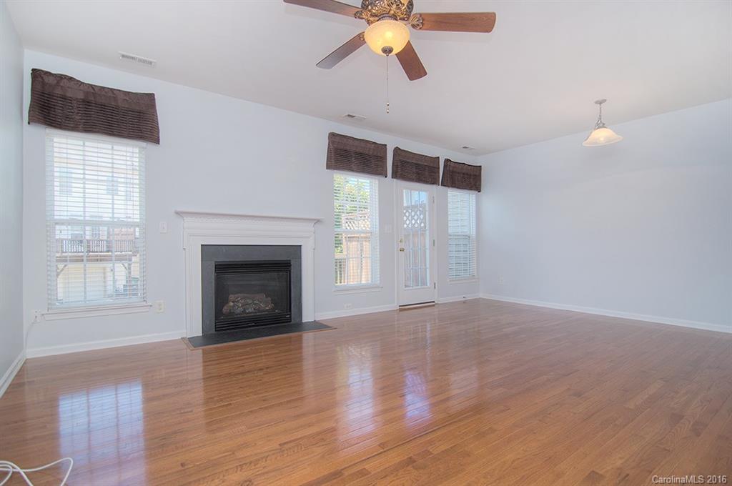 7510 Turley Ridge Lane Charlotte, NC 28273 - Photo 7 of 23 a view of an empty room with wooden floor fireplace and a window