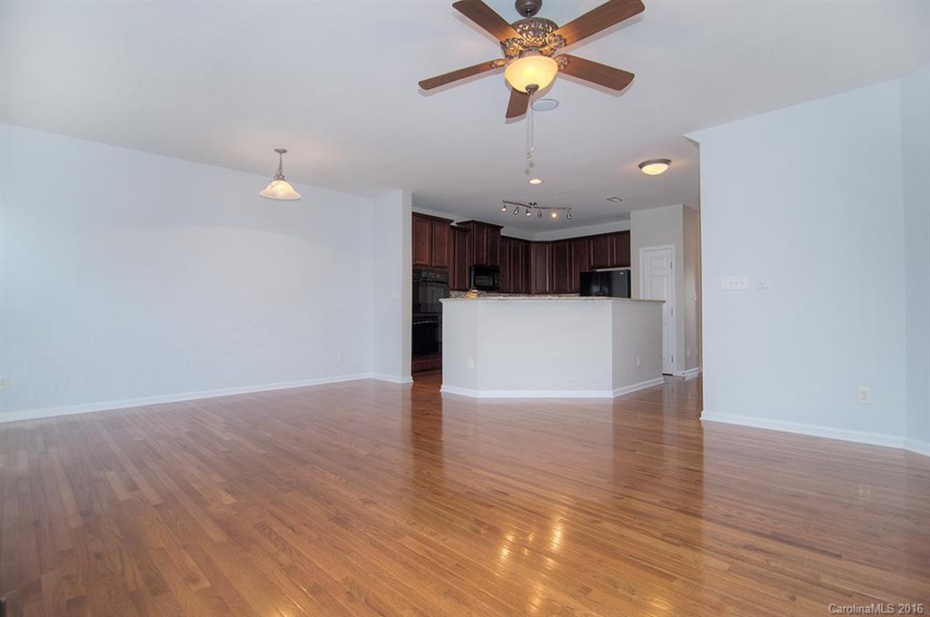 7510 Turley Ridge Lane Charlotte, NC 28273 - Photo 8 of 23 a view of a kitchen with a wooden floor and a ceiling fan