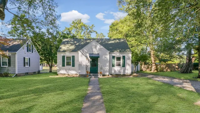 a front view of house with yard and green space