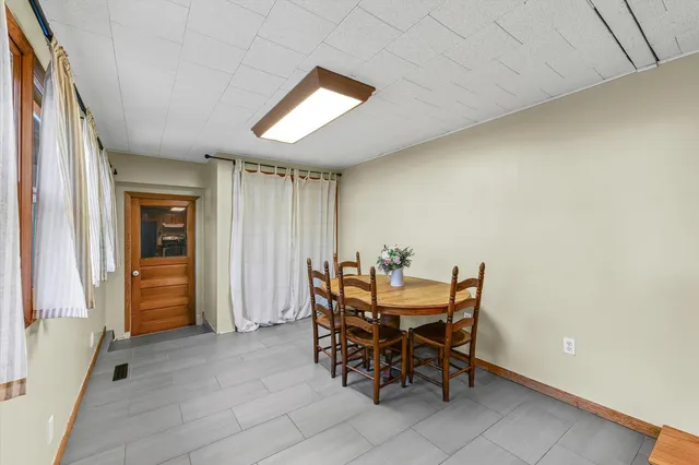 a view of a dining room with furniture and window
