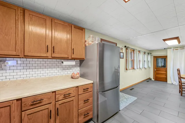 a kitchen with stainless steel appliances granite countertop a refrigerator and a sink