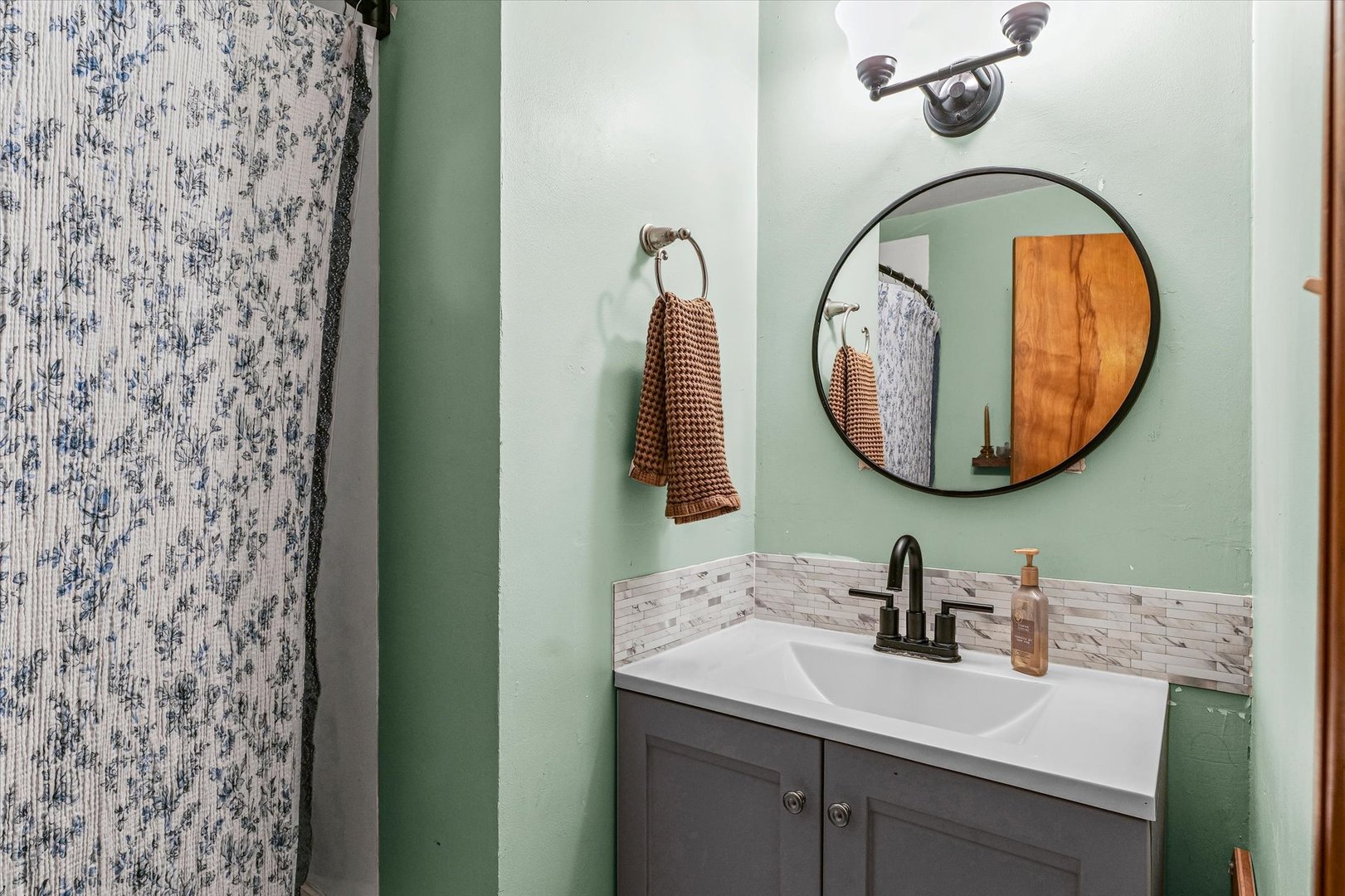 505 North Calhoun Street Tolono, IL 61880 - Photo 19 of 31 a bathroom with a sink and a mirror