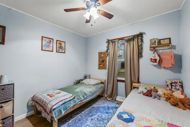 a bedroom with a bed and a chandelier