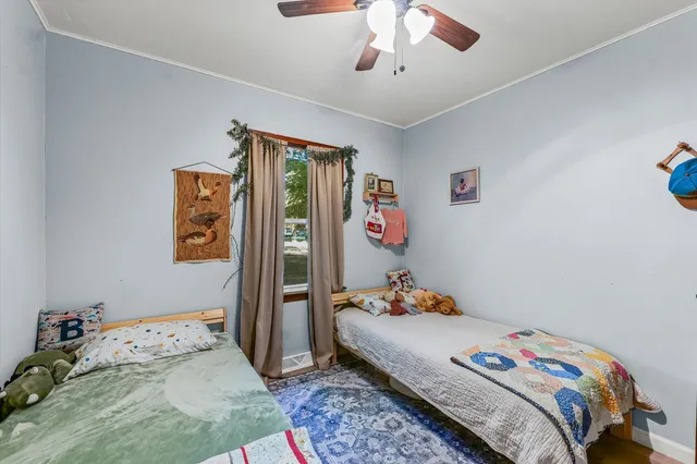 a bedroom that has a bed and a chandelier