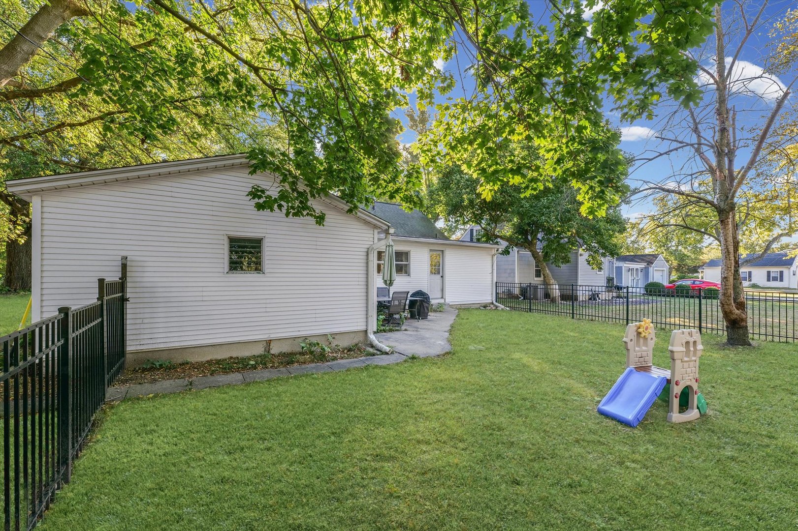 505 North Calhoun Street Tolono, IL 61880 - Photo 26 of 31 a view of a backyard with table and chairs and a slide